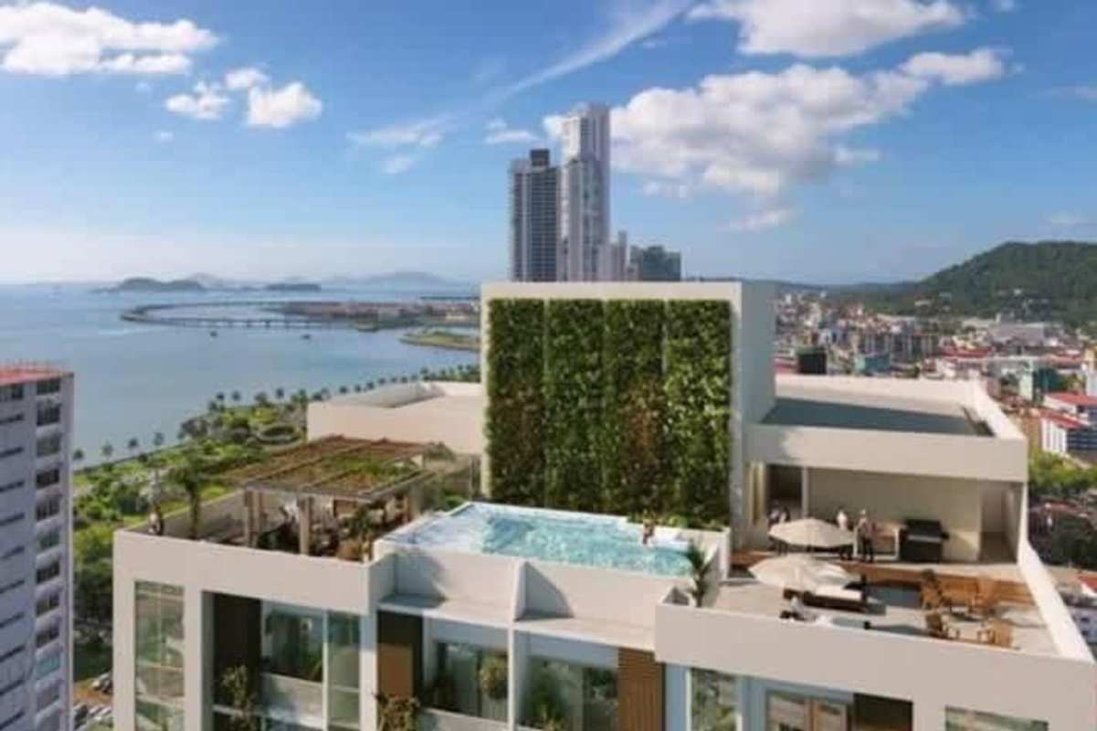 Rooftop terrace with swimming pool lounge areas ocean view at Alexa Towers Panama City