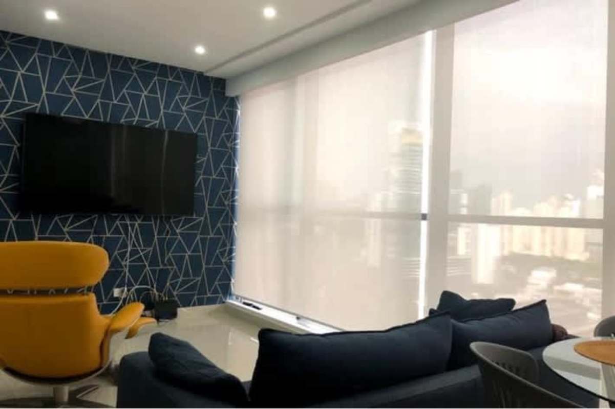 Modern living dining zone with blue and yellow decor and skyline views in Obarrio Panama