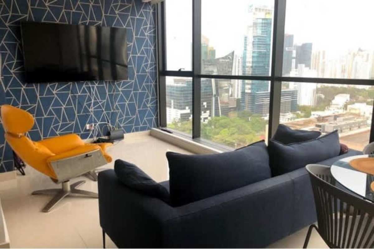 Stylish living room with panoramic city views floor-to-ceiling window Obarrio Panama rental
