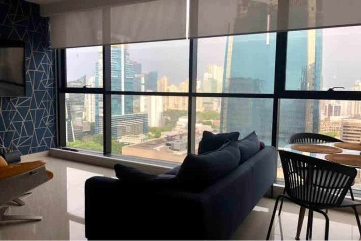 Dining area with glass table, black chairs, skyline background, PH Obarrio Tower Obarrio Panama