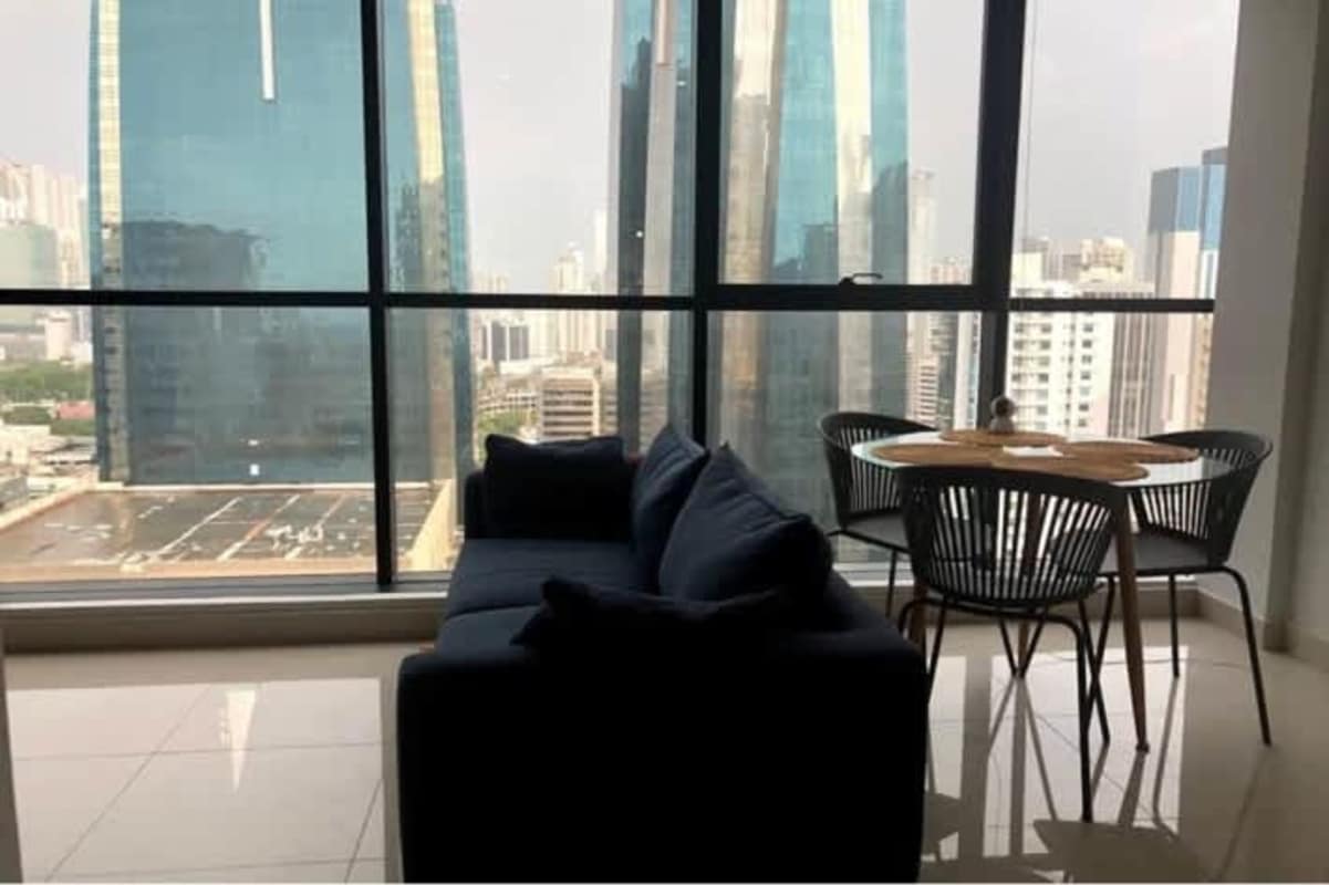 Modern apartment rental living room Obarrio Panama skyline vista floor-to-ceiling windows