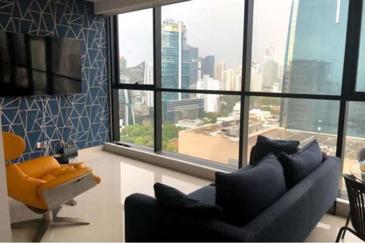 Apartment rental living room with blue accent wall city view tower Obarrio Panama