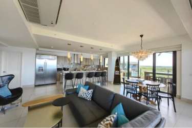 Luxury open living dining kitchen area with Pacific ocean view Solaris Punta Caelo