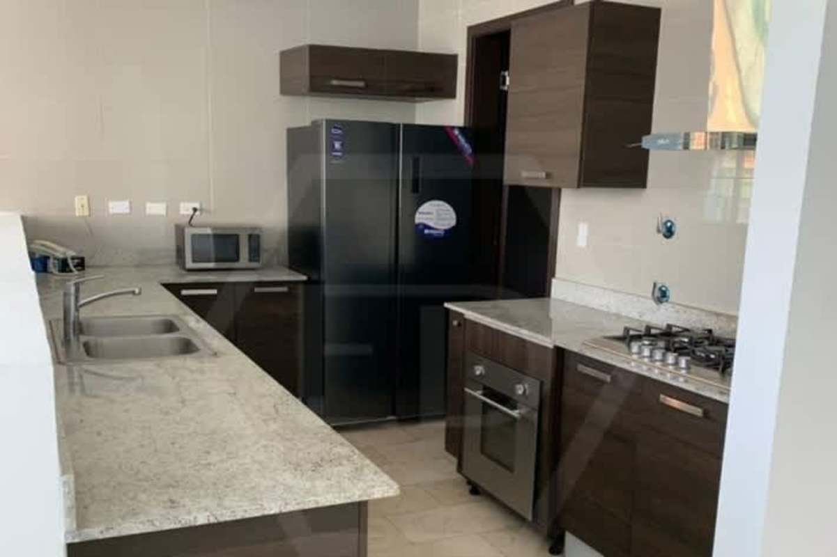 Modern kitchen with granite counters, stainless appliances, built-in oven at PH Ocean Club loft Punta Pacifica Panama