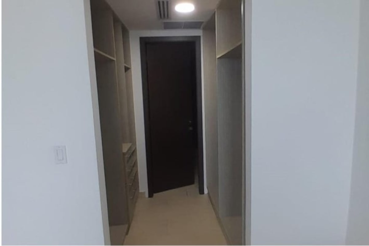 Spacious walk-in closet with custom shelves and drawers in luxury loft apartment PH Ocean Club Panama City