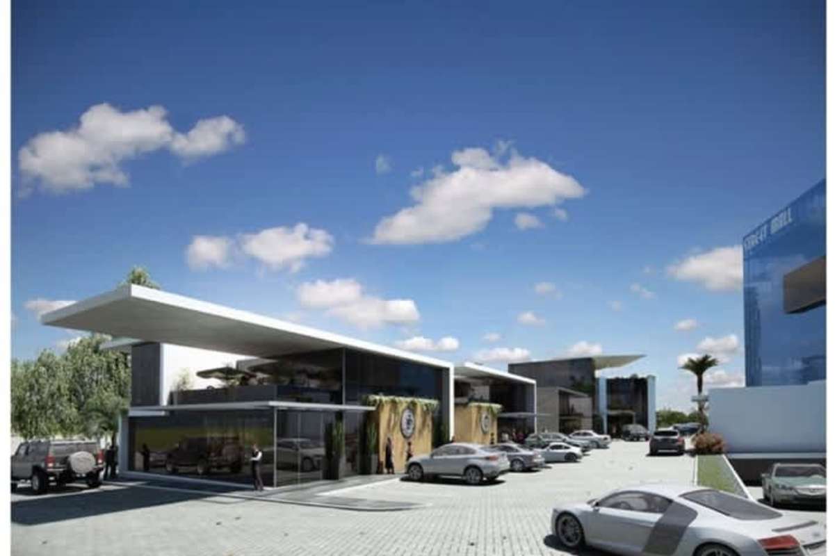 Multi-tenant commercial plaza with glass facades, landscaped gardens and parking in Panama City