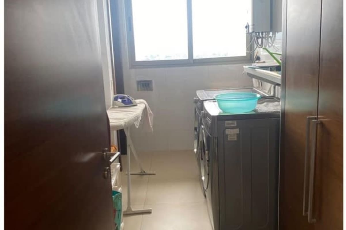 Laundry room with washer dryer and maid's quarters in PH Greenview Santa María Panama
