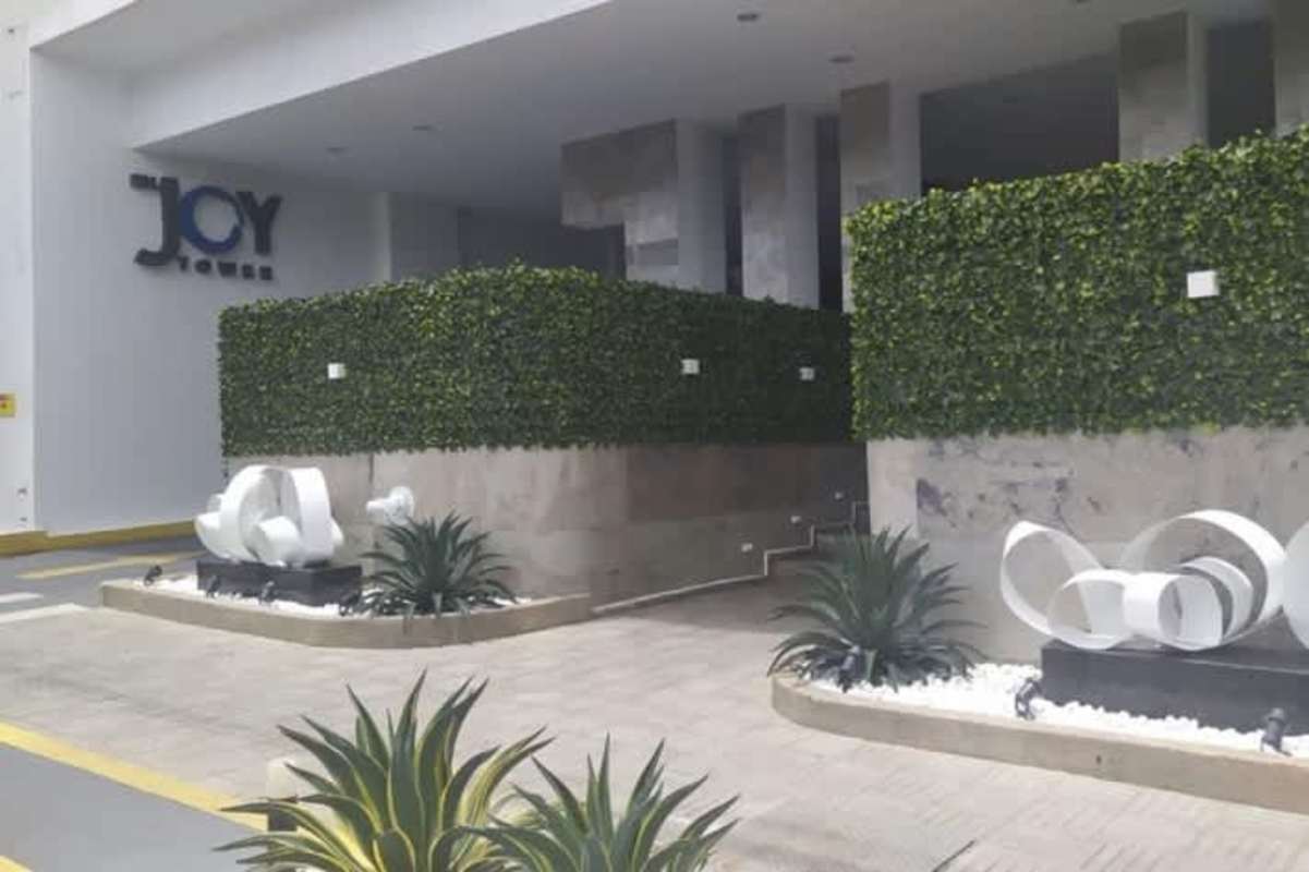 Luxury high-rise facade with landscaping and art sculpture PH Joy Tower in Panama City