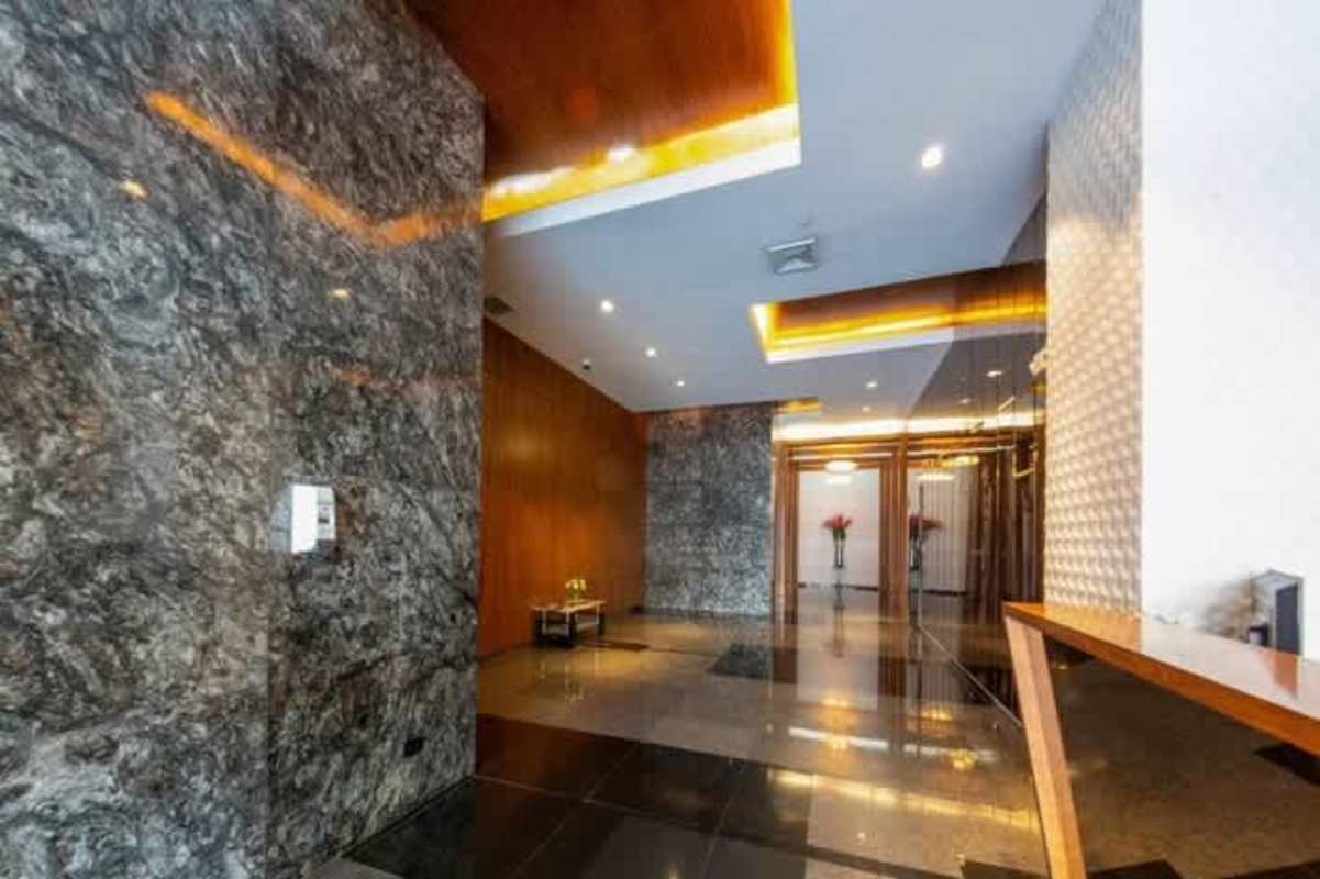 Lobby with marble walls recessed lights reflective floor PH Via Brasil Business Center Panama