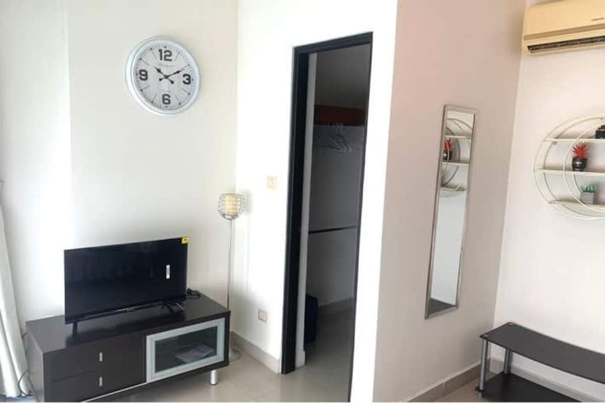 Modern bedroom with city skyline view, built-in wardrobe, flat TV at PH Pacific Sea