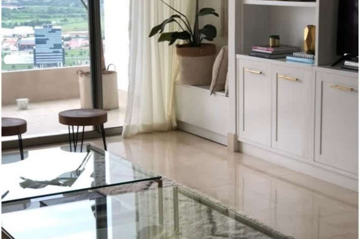 Modern living room with floor to ceiling glass doors and golf course view PH Greenview Santa María Panama