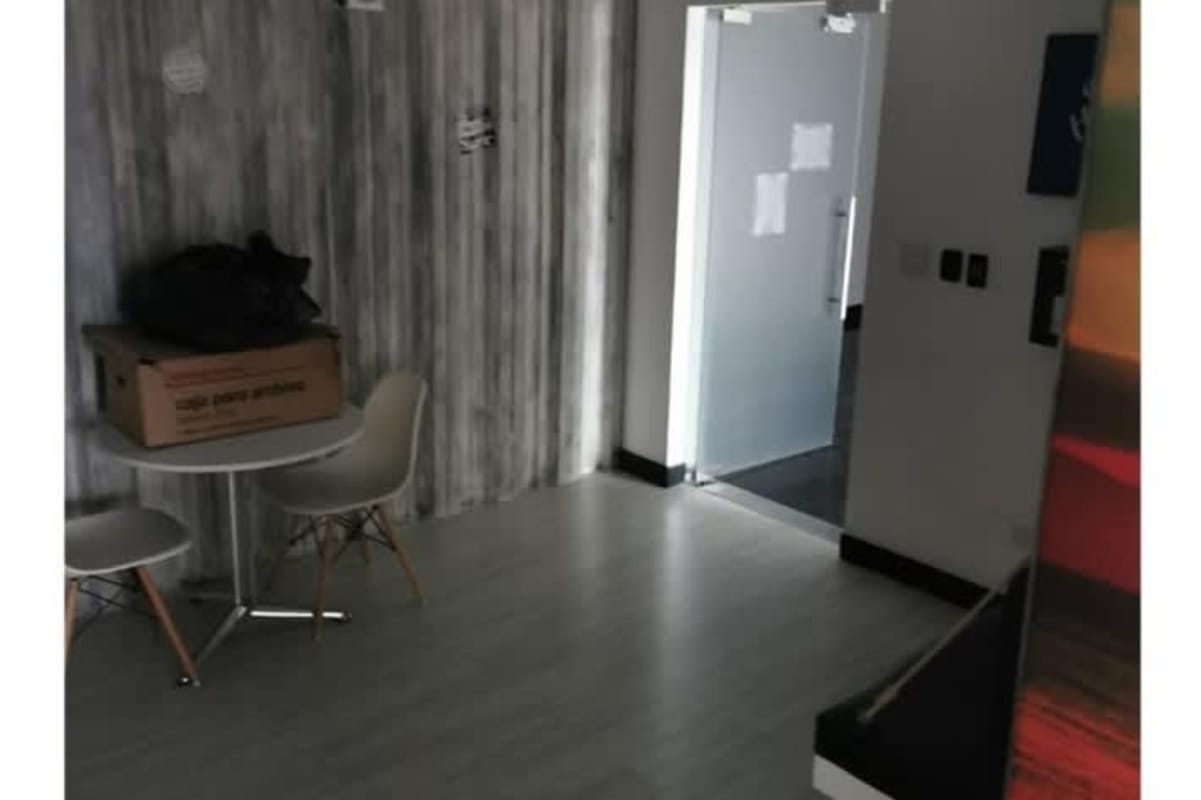 Tall glass skyscraper of Tower Bank in Panama City against blue sky