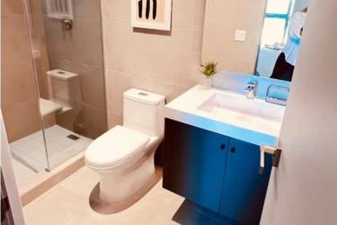 Modern bathroom with vanity, glass shower, decorative elements for rent Panama Pacifico