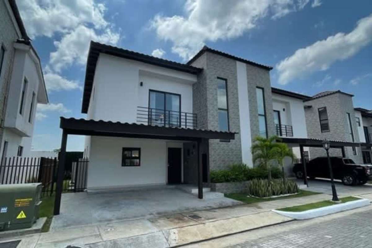 Two-story modern house with balcony brick accent and carport Costa Sur Panama