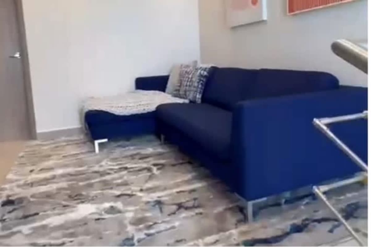 Stylish living room with blue sectional sofa and modern art in Costa Sur house Panama