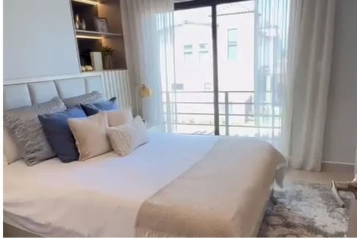 Bedroom with large bed and floor to ceiling window for sale Costa Sur Panama