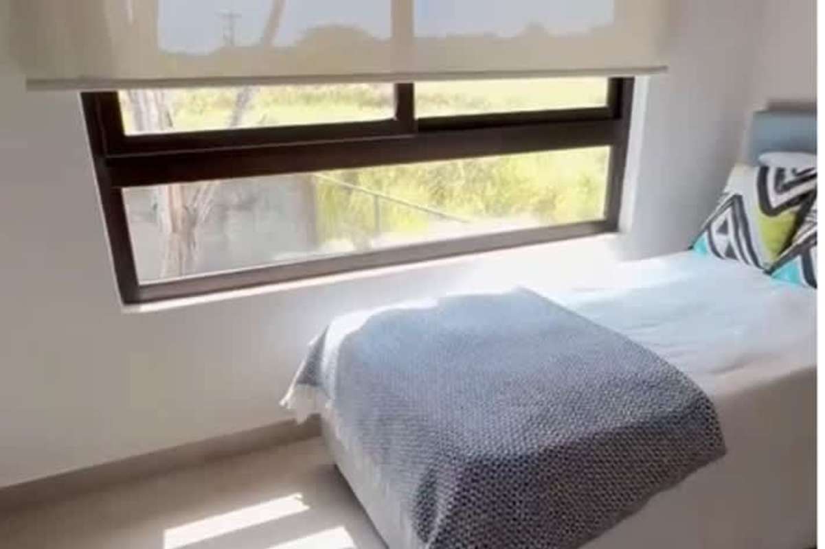 Bedroom with natural light and window view in family house Costa Sur Panama