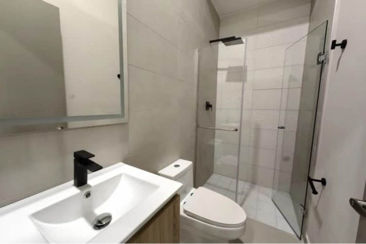 Bedroom decorated with accent wall and city view Seaside House