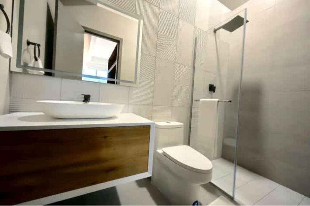 Large windows in bedroom offering city views Seaside House Panama