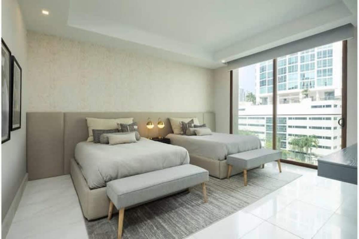 Bedroom with double queen beds panoramic windows contemporary design The Residences Punta Pacifica Panama City