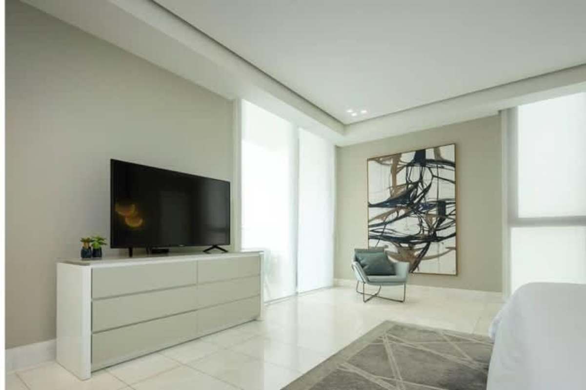 Spacious bedroom with large windows, city skyline views, walk-in closet and elegant furnishings in The Residences Punta Pacifica