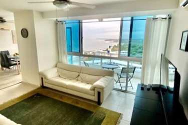 Spacious living room with large windows, balcony access, and ocean view in PH Coronado Bay Panama