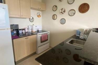 Contemporary kitchen with granite countertops, appliances, and large window PH Coronado Bay Panama