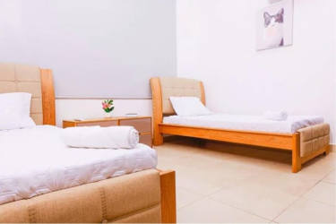 Modern dining room with glass table blue chairs bright Coronado beach house