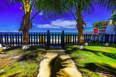 Pool area with lounge chairs tropical landscaping beach house Coronado Panama