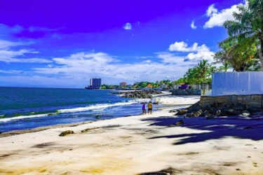 Tropical beachfront with ocean waves palm trees blue sky near Paradise Point Coronado Panama