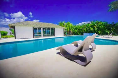 Large swimming pool with sun loungers tropical landscaping Paradise Point Coronado Panama