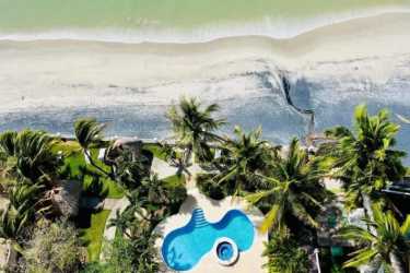 Aerial photo showing tropical beachfront pool area with jacuzzi, gardens at PH Biltmore Nueva Gorgona Panama