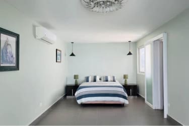 Contemporary kitchen with artisan counters embedded with shells, glass lighting, wood cabinets, oceanview at PH Biltmore Nueva Gorgona