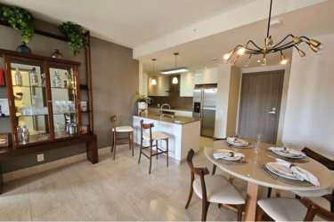 Modern open kitchen with island, stainless appliances, adjoining dining area in Explora Panama Pacifico