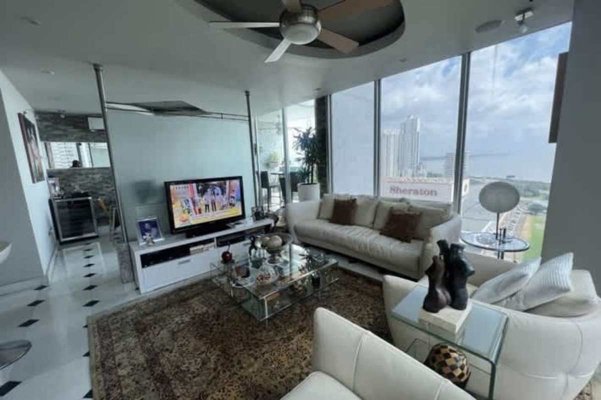 Luxurious master bedroom with large windows overlooking ocean skyline in PH Prive San Francisco