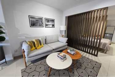 Contemporary living space with gray sofa, decorative accents, city view in Santa Ana Panama