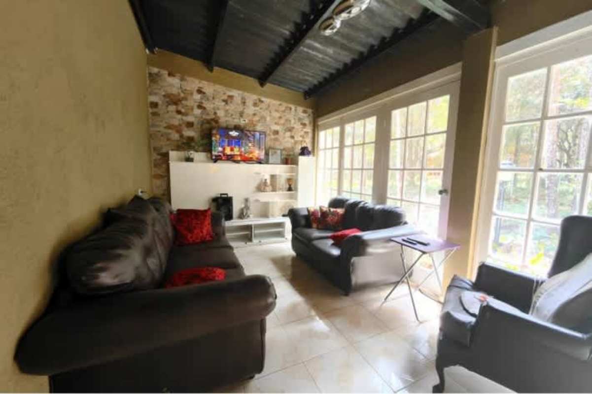 Covered terrace balcony overlooking dense forest in mountain community Altos de Cerro Azul