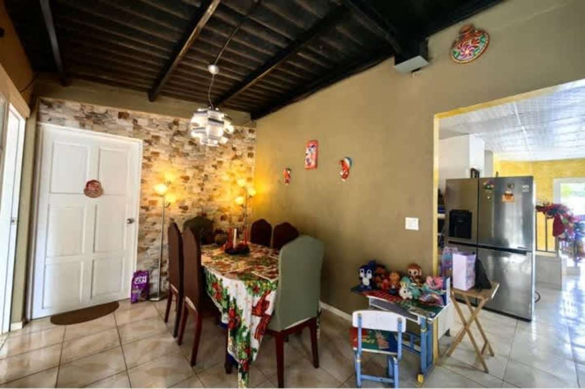 Spacious living area with stone accent wall and black seating mountain home Altos de Cerro Azul