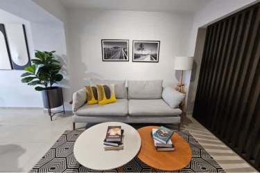 Contemporary living room with gray sofa decor, modern art, and bright space in Santa Ana Panama