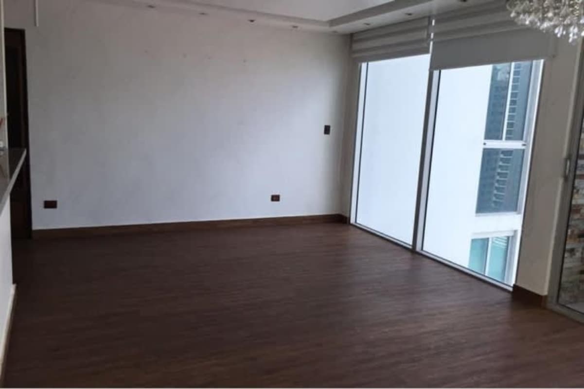 Bedroom with dark wood floor, AC, and city views in PH San Francisco Panama