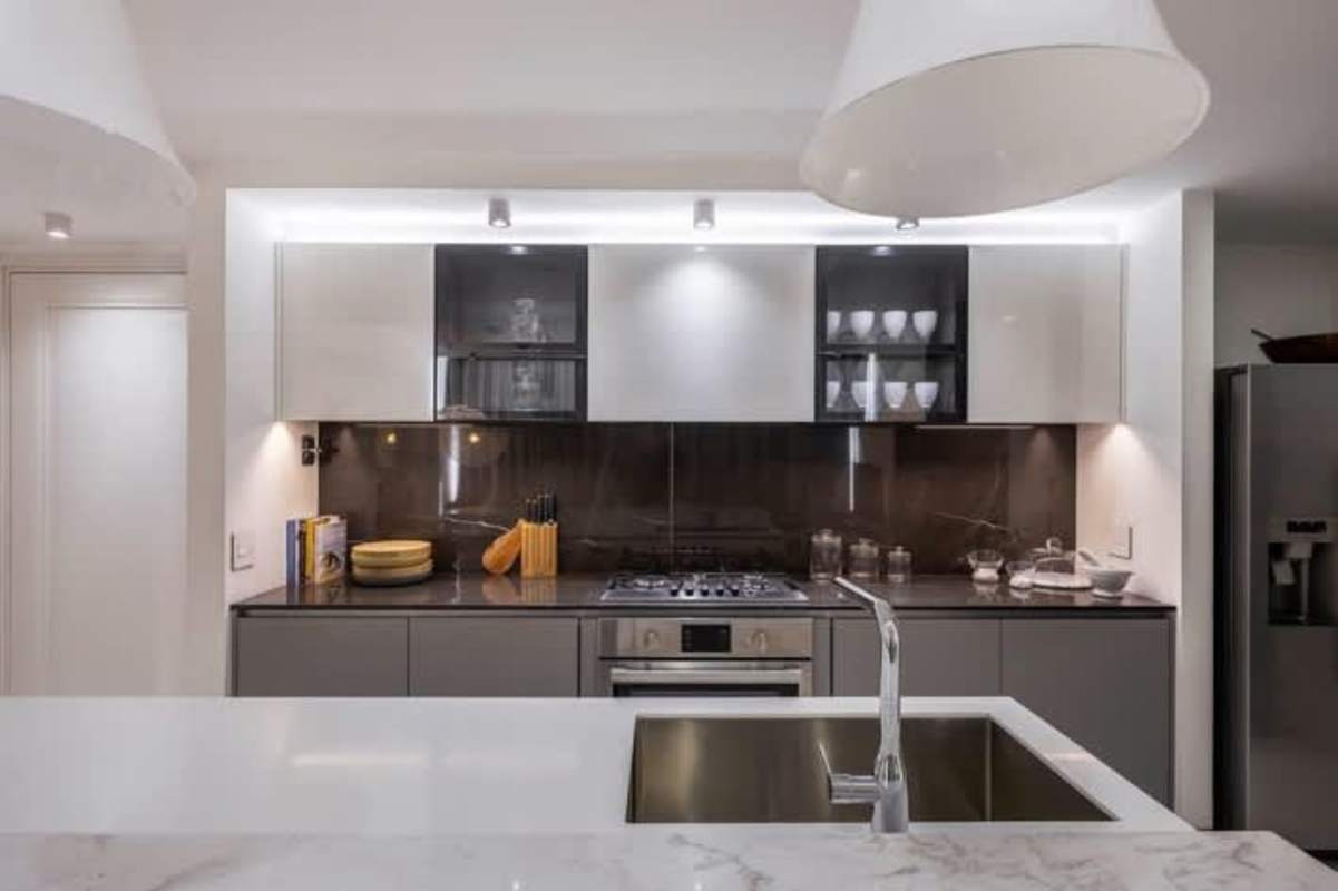 Modern bathroom with marble walls, glass shower, floating vanity luxury apartment PH Hyde Panama