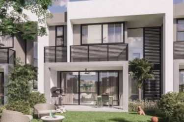 Contemporary townhouse exterior with balcony, large windows and garden views at Imaterra Panama Pacifico
