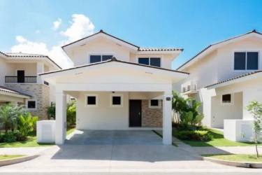 Modern kitchen with wood cabinetry and L-shaped counter in Bosques del Pacífico Panama