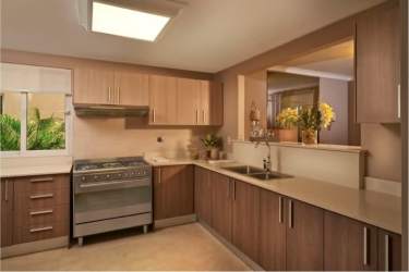 Spacious bedroom with large windows and built-in closet at Bosques del Pacífico Panama Pacifico