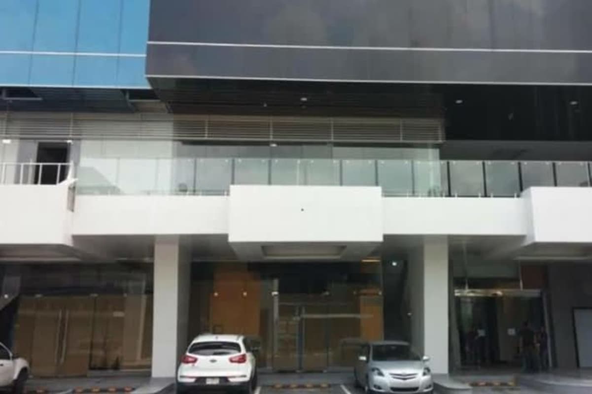 Glass exterior and parking lot of Obarrio's Atrium Tower office complex