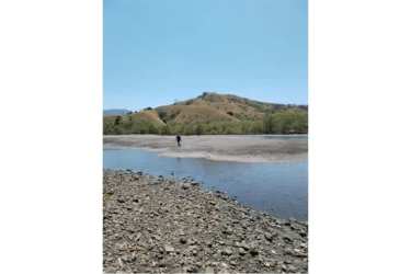 River inlet with rocky shore, gentle hills and Pacific coastline Punta Naranjo