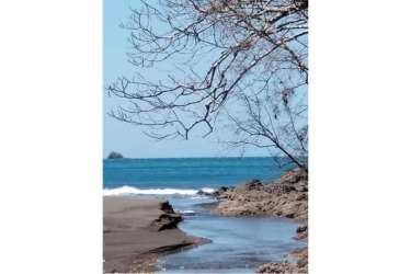 Wide sandy beach, rocky inlets, tropical forest backdrop on Panama Pacific coast