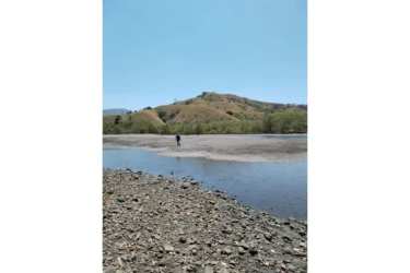 Rocky coast riverbank with mountain views rural coastal land Punta Naranjo