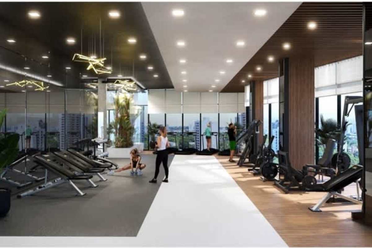 Large gym with floor-to-ceiling windows and skyline views in PH Coco del Mar Panama City