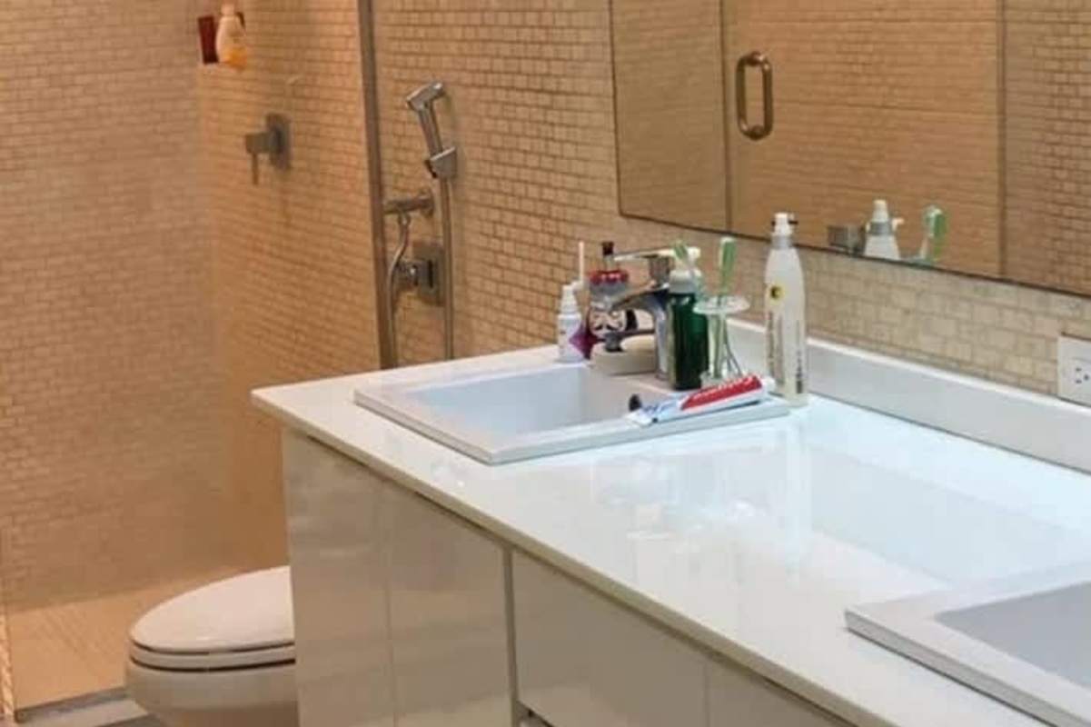 Contemporary bathroom with double sinks, large mirror, walk-in shower in remodeled La Alameda Panama house